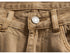 Close-up of tan wide-leg jeans waistband, showcasing button and pocket construction