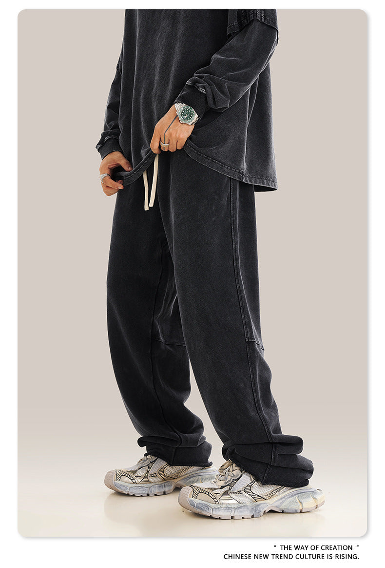 Close-up of front pocket and drawstring detail on charcoal sweatpants, showing white contrast drawstring
