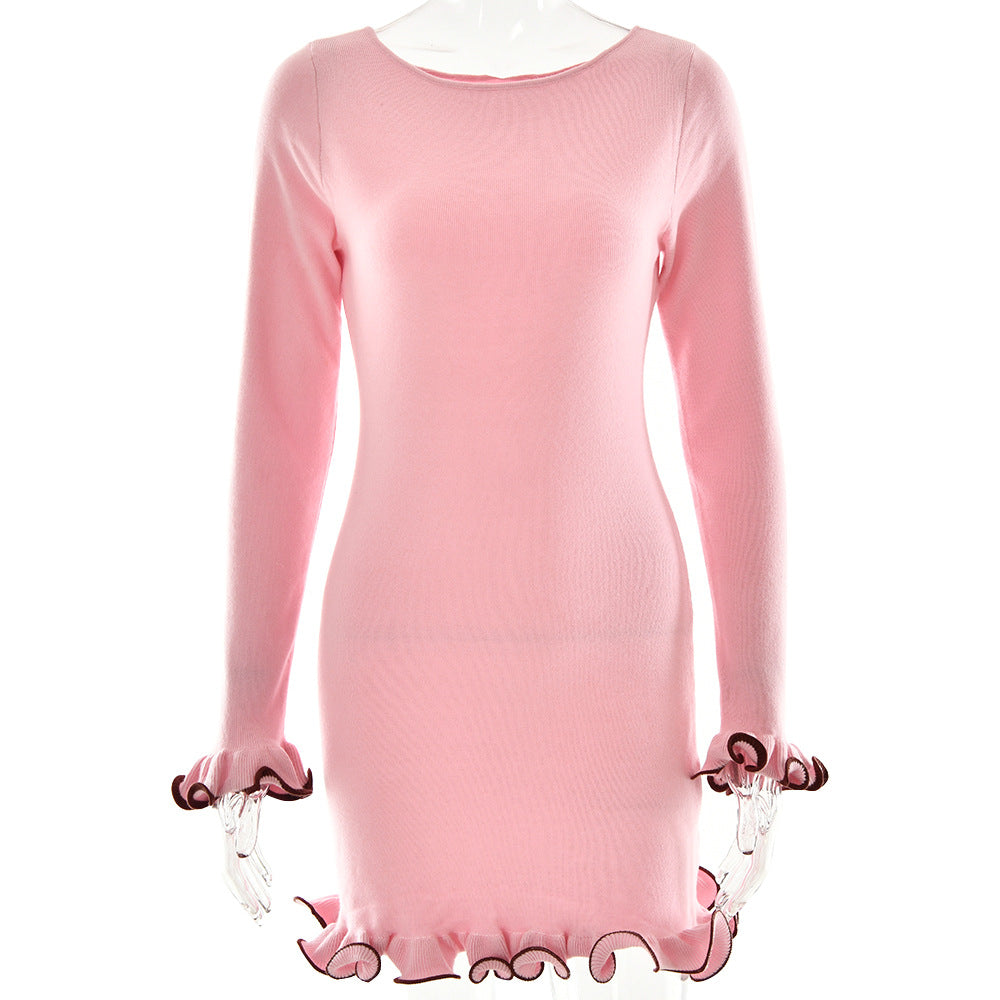Light pink long-sleeve mini dress with brown contrast ruffle trim on display, showing fitted silhouette