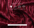 Close-up of burgundy ribbed velvet fabric with safety icons showing comfortable, ventilation, soft fabric, and harmless properties