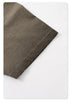 Close-up of taupe t-shirt hem showing double-needle stitching and raw edge distressing