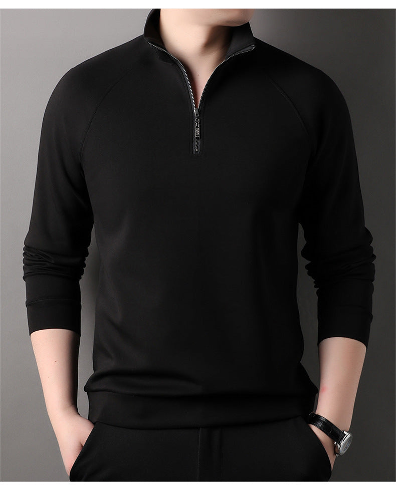 Black quarter-zip pullover sweater with standing collar and raglan sleeves shown against gray background