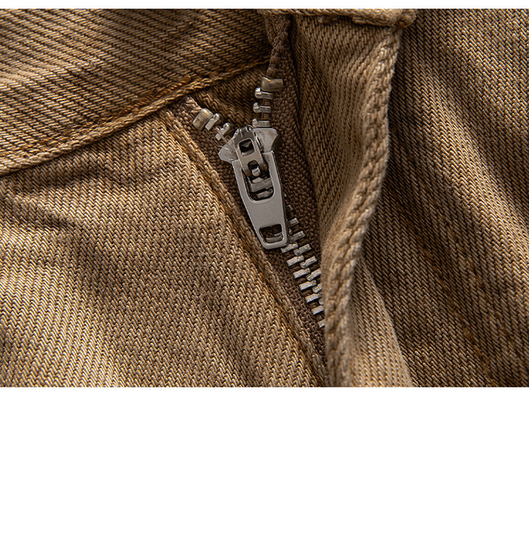 Close-up of brown wide-leg jeans zipper, demonstrating sturdy metal teeth and pull