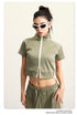 Light green crop top with white zip front, mock neck, short sleeves, white side stripes
