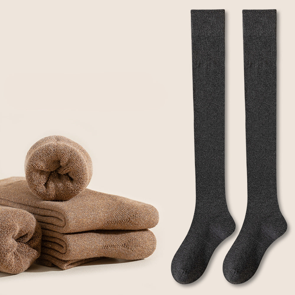 Dark charcoal knee-high socks displayed with stacked beige socks and red indicator button