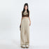 Full-length view of beige palazzo pants with elastic waist and wide-leg silhouette, paired with white platform sneakers