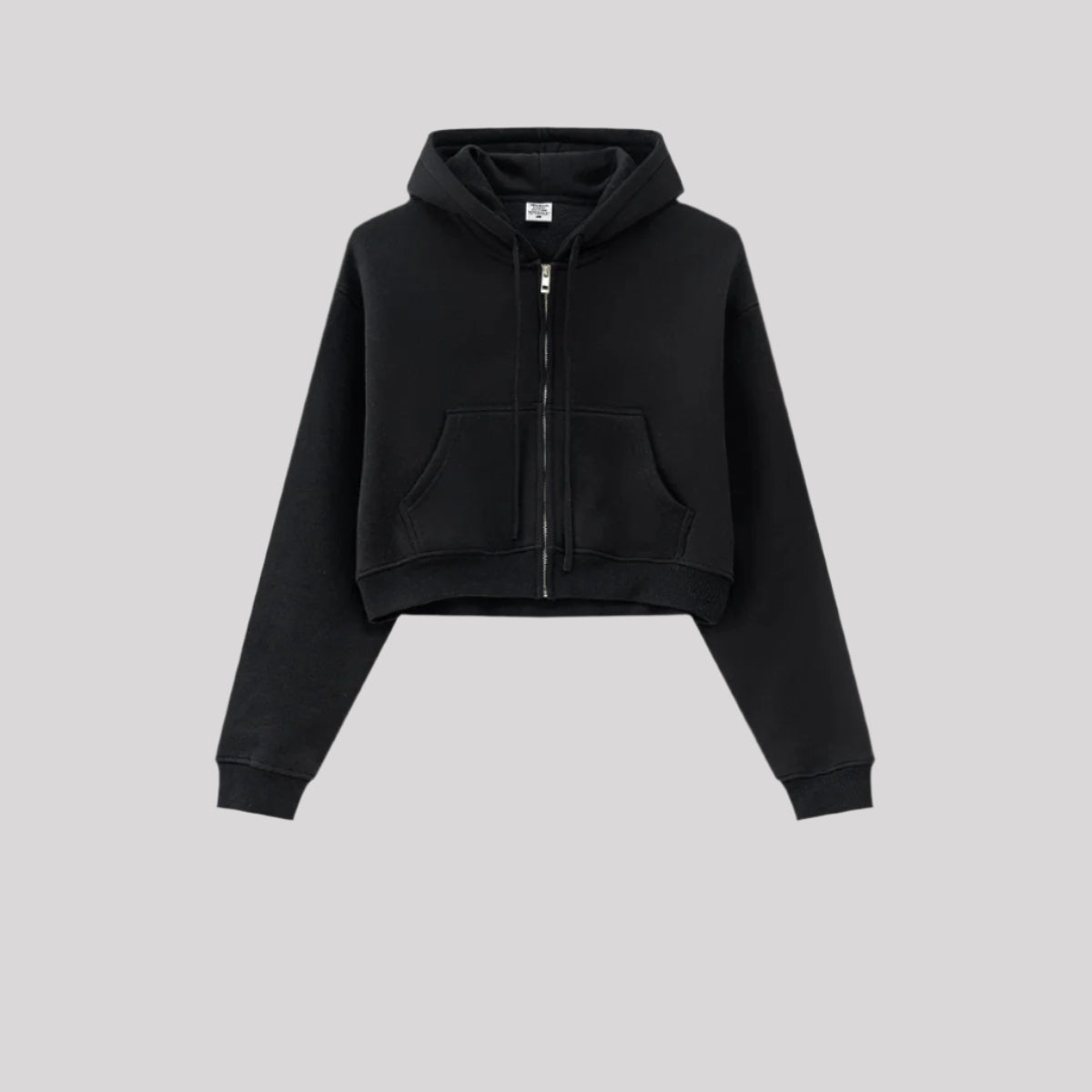 Black cropped zip hoodie with front pocket against gray background. Features silver zipper and ribbed hem