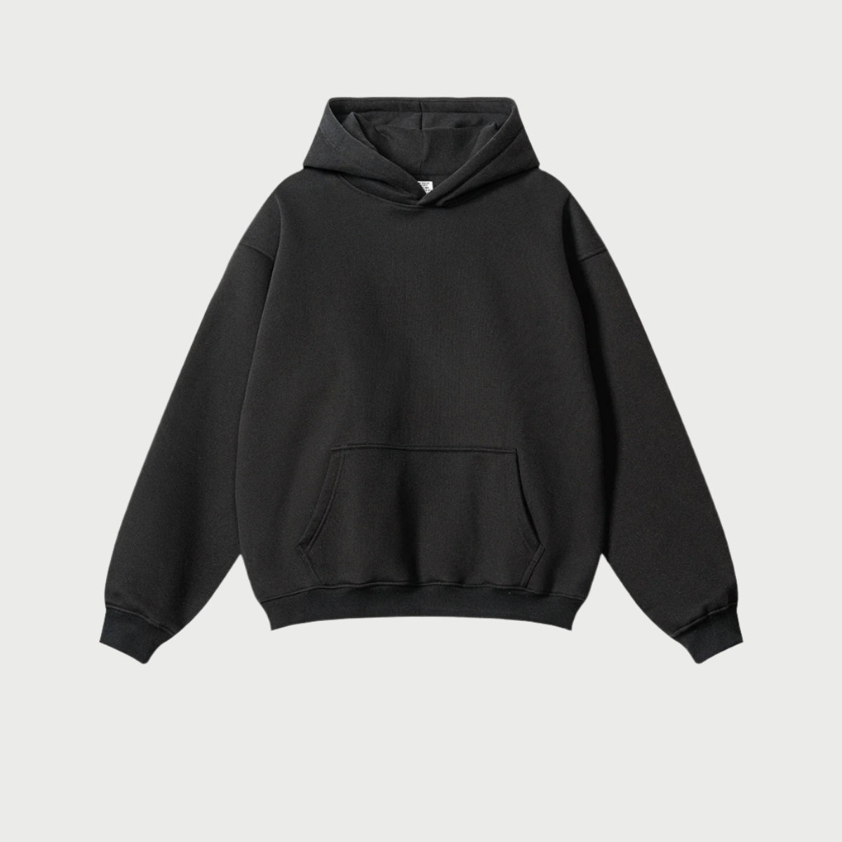 Classic black oversized hoodie with front pocket on light gray background