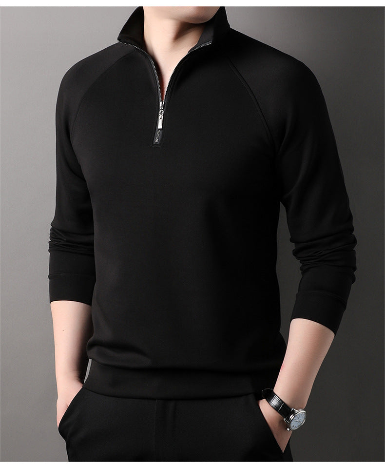 Front view of black quarter-zip pullover sweater with silver zipper pull and minimalist design against gray background