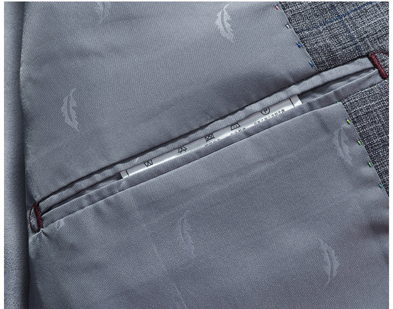 Interior view of gray suit jacket showing smooth lining with care label and inner pocket construction