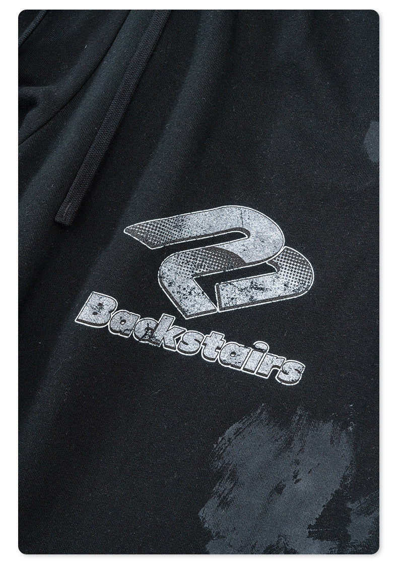 Backstairs logo printed on black sweatpants with distressed silver graphic effect
