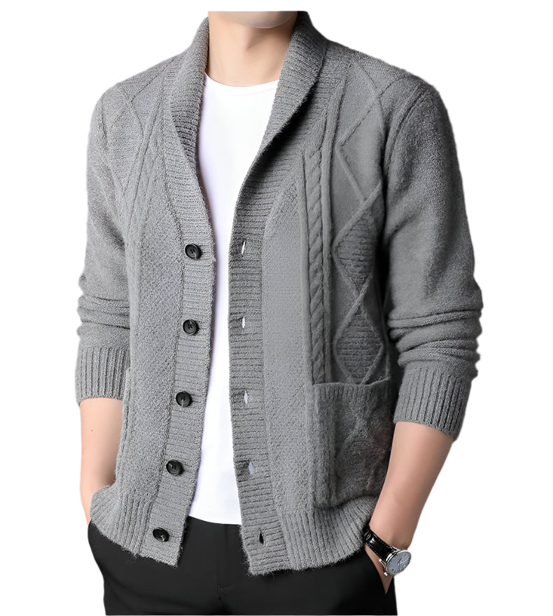 Close-up view of light gray shawl collar cardigan showing detailed cable knit pattern, black button placket, and patch pocket detail