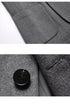 Close-up details of the gray blazer showing the pocket construction and black button