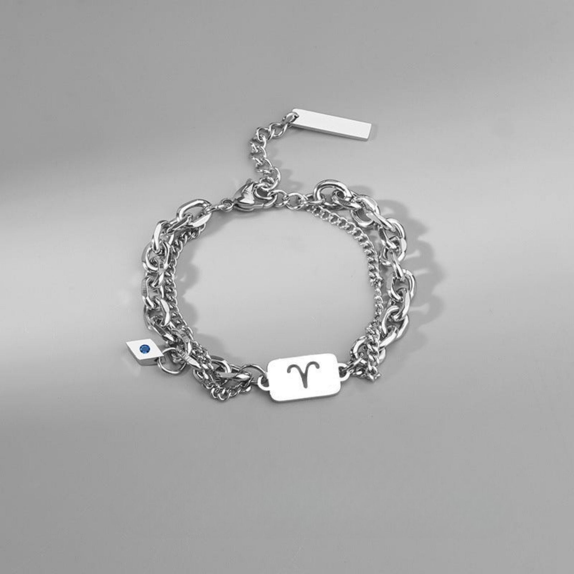 Aries zodiac bracelet in stainless steel, featuring a bold engraved charm and layered chain design for a modern look.