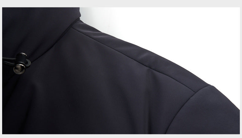 Detailed view of the coat’s shoulder, showing the smooth black fabric and an adjustable drawstring with a stopper