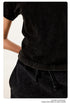Detail shot of black t-shirt and skirt fabric texture and drawstring construction