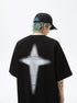A man is shown from behind wearing black tee with contrasting white cross graphic. Features blue-green hair, black cap and small neck tattoo visible