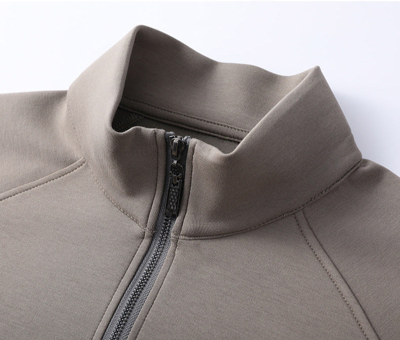 Close-up of taupe quarter-zip collar detail showing quality stitching and gunmetal zipper hardware