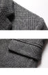 Detail of gray glen plaid blazer lapel and sleeve showing fabric texture, pattern alignment and tailored construction at shoulder seam.