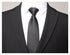 Close-up of black suit lapels and collar with white dress shirt and diagonal striped black tie, showing front chest detail
