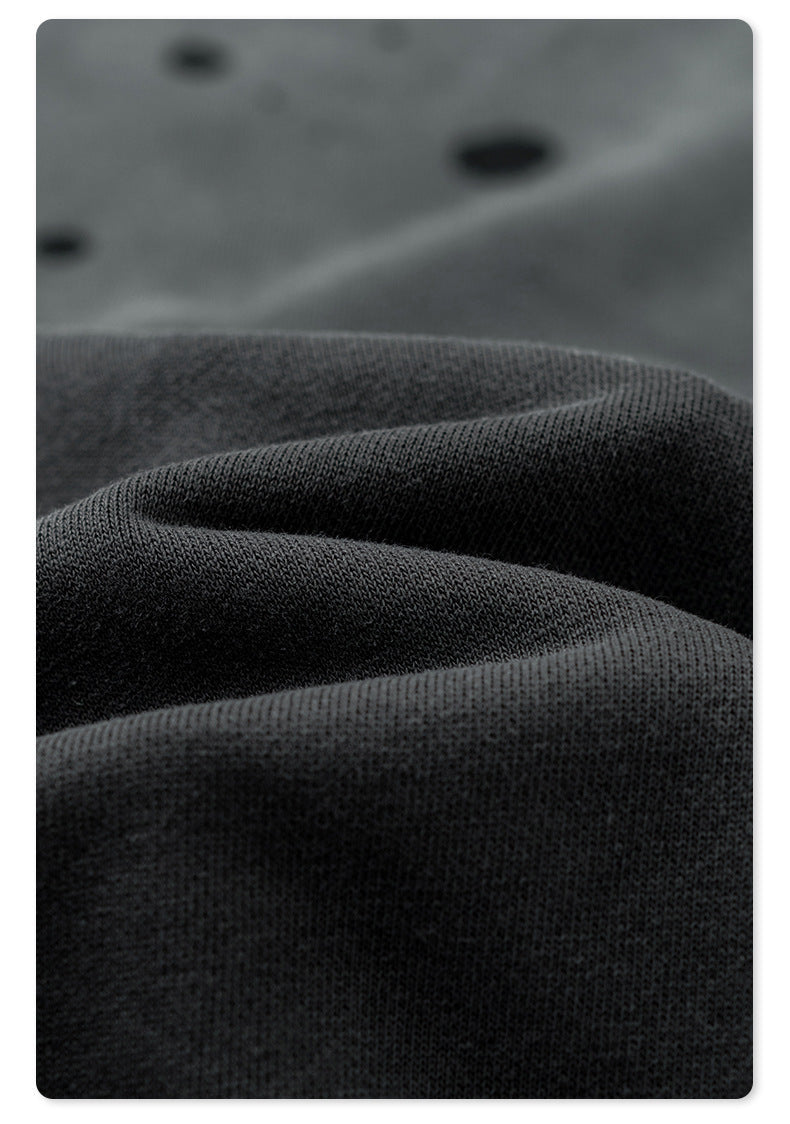 Close-up of black cotton fabric texture showing knit pattern