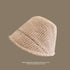Beige textured bucket hat shown from side angle with ribbed texture against taupe background, foldable summer design
