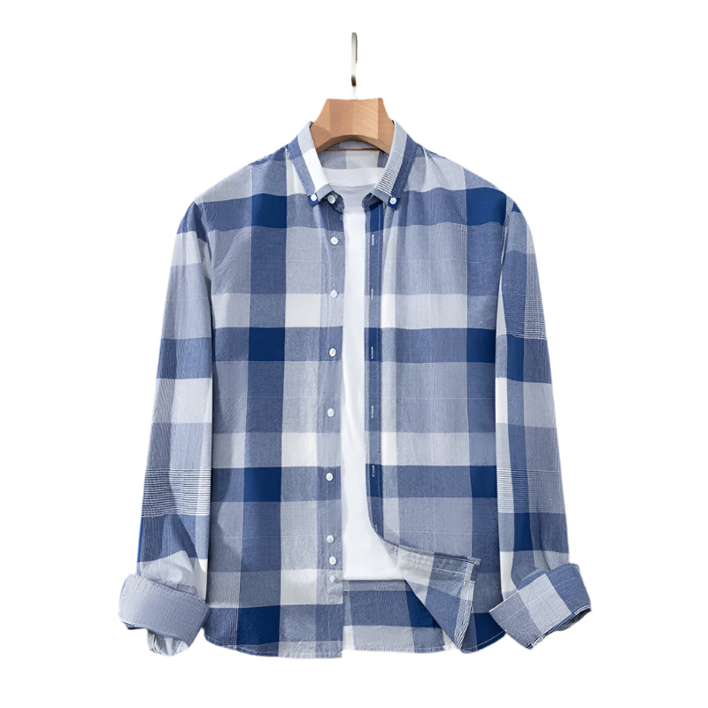 Medium blue checkered button-down shirt on wooden hanger. Classic pattern in cotton fabric