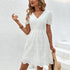 Elegant white lace dress with a scalloped hem, accessorized with gold jewelry and a straw bag, perfect for a summer outfit