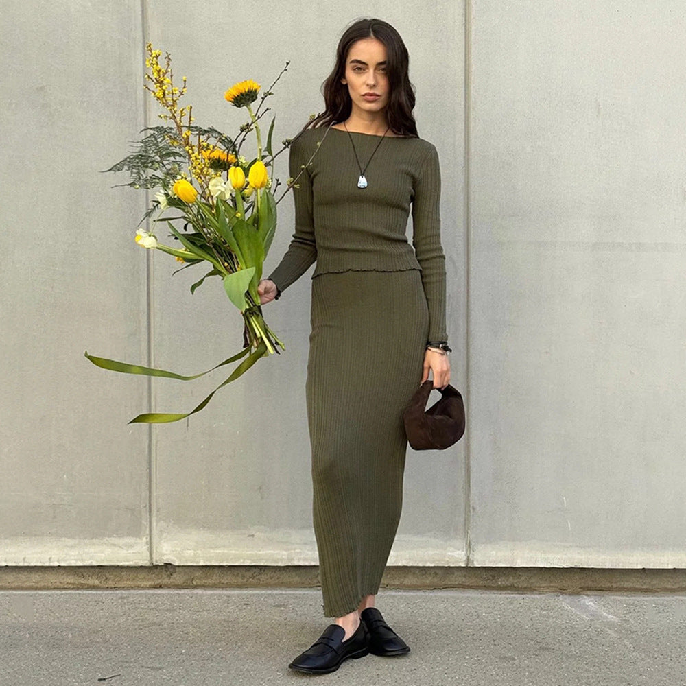 Olive green ribbed dress with sunflower bouquet and brown handbag, modern minimalist street style outfit