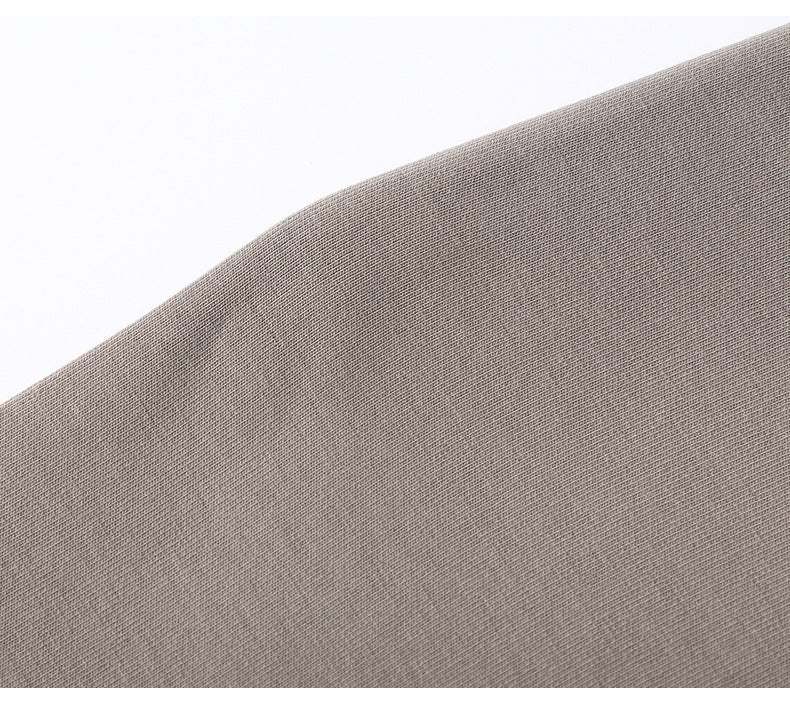 Close-up of light gray cotton fabric texture showing smooth surface and fine knit pattern