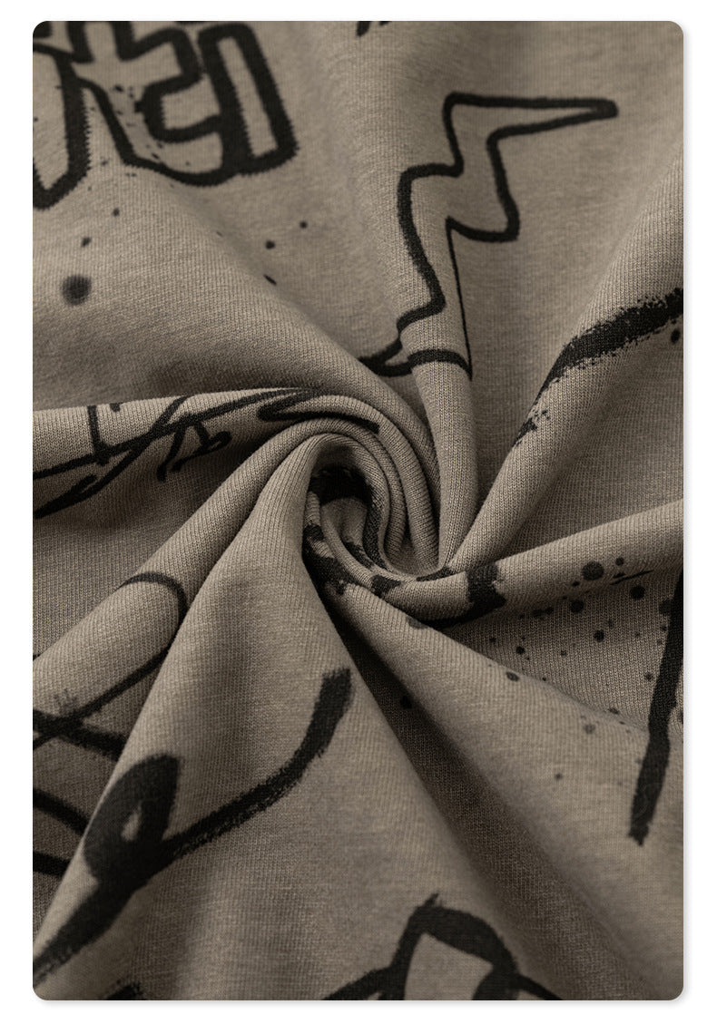 Twisted fabric detail showing drape and stretch quality of taupe cotton with black graffiti prints