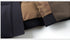 Zoomed-in view of the coat’s inner lining, displaying the contrast between the black exterior and brown interior fabric