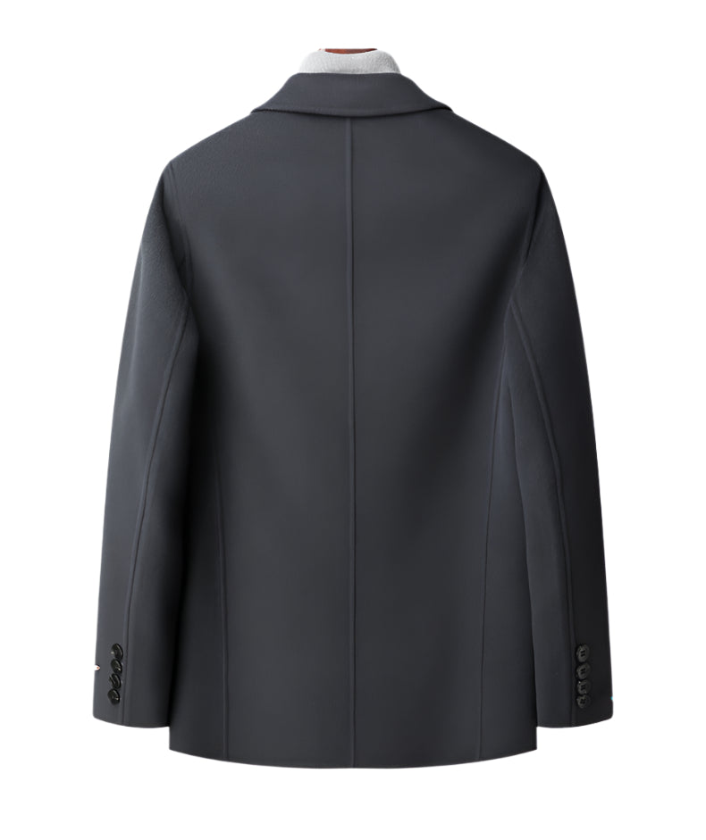 Back view of charcoal wool blazer showing center vent and tailored seams with button cuff detail