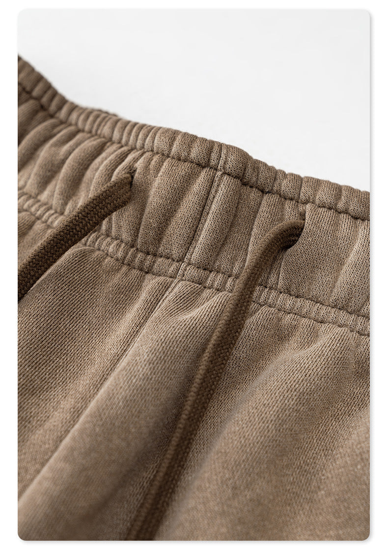 Close-up of taupe sweatpants elastic waistband stitching and fabric detail