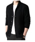 Front view of black button-up cardigan with geometric cable knit pattern, shown with white undershirt against neutral background