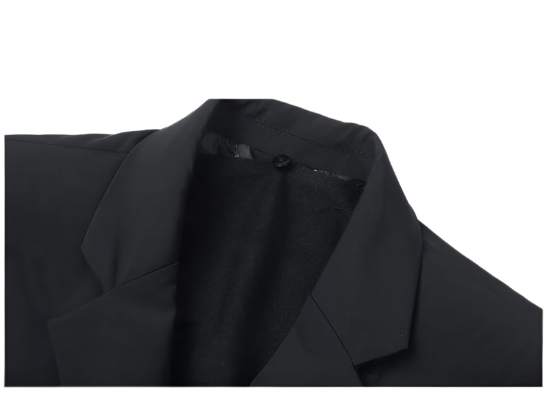 Close-up of coat lapel construction and collar detail with contrasting fabric textures