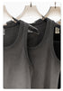 Detailed view of gray and black tank tops, highlighting soft washed fabric and reinforced stitching