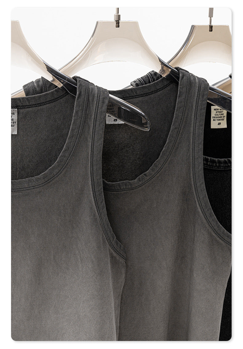 Detailed view of gray and black tank tops, highlighting soft washed fabric and reinforced stitching