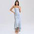 A model is wearing a powder blue jacquard evening gown with ruched waist, high-low hem and corset bodice, standing against white background