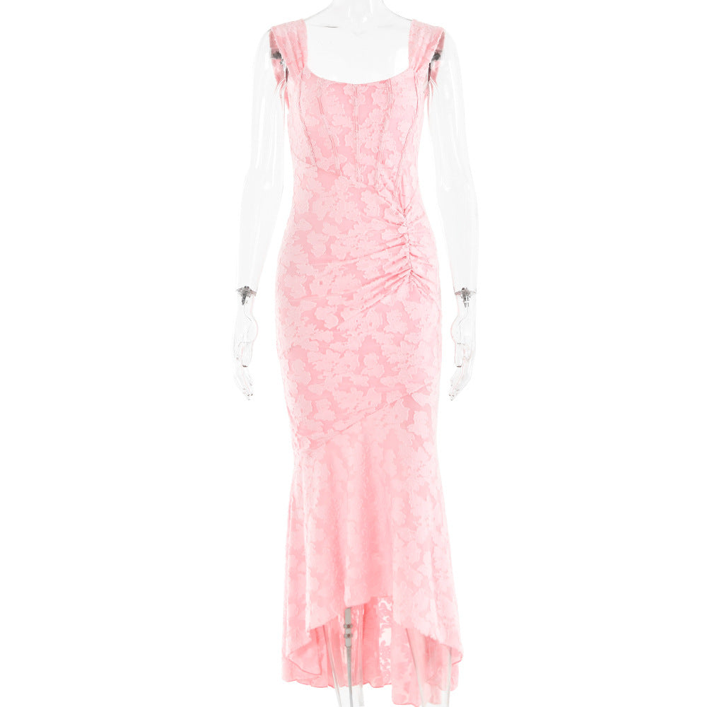 A pink jacquard evening gown with ruched detailing and fishtail hem displayed on mannequin against white background