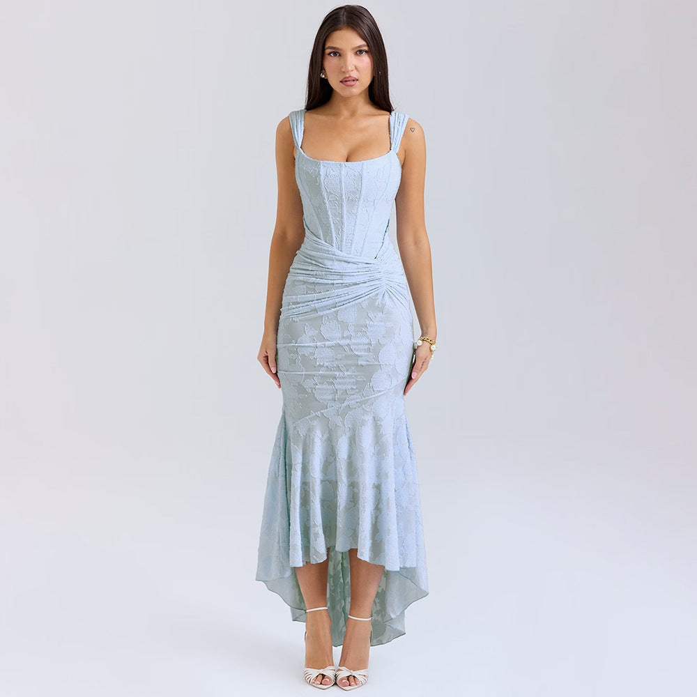 A model is wearing a light blue textured gown with corset bodice, ruched waist and high-low hemline, posing against white background