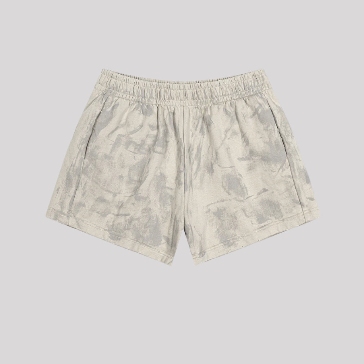Light beige cotton shorts with elastic waistband and subtle gray wash pattern on light background