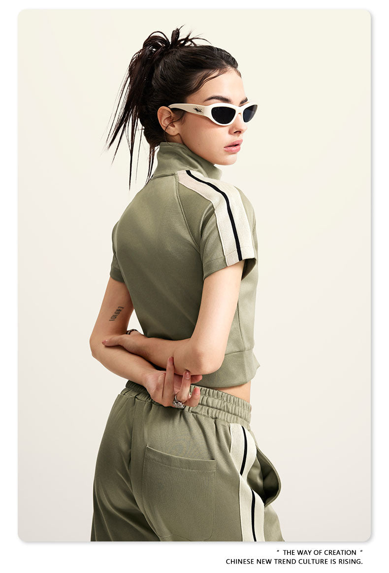 Light green crop top with white zip front, mock neck, short sleeves, white side stripes (side view)