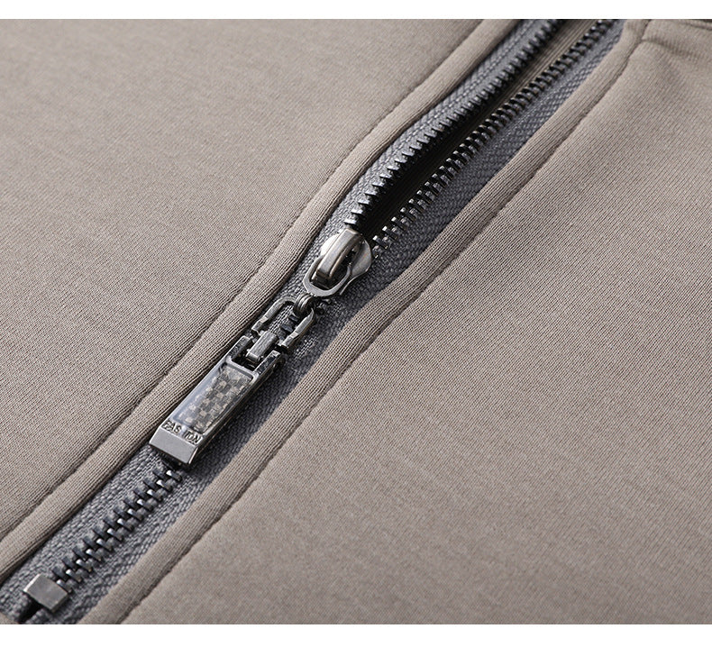 Detail of taupe quarter-zip sweater zipper with carbon fiber-look pull tab and premium metal teeth
