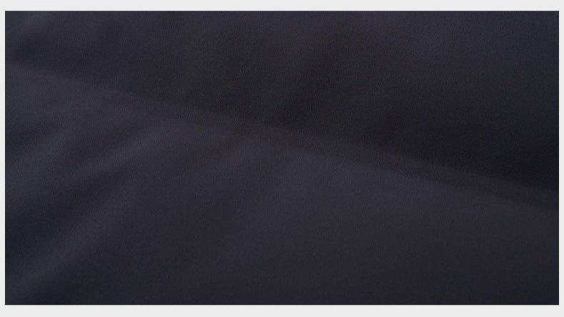 A macro shot of the black fabric surface, showcasing its water-resistant and smooth texture