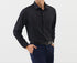 A model is wearing a black button-up shirt with navy trousers and black belt. One hand in pocket showing gold watch detail
