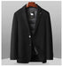 Navy wool blazer with lapel detail showing DOWN FILLER sheep logo tag and silver 'R' lapel pin