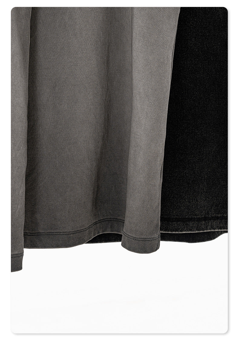 Bottom hem of gray and black tank tops, showcasing the raw, washed fabric finish