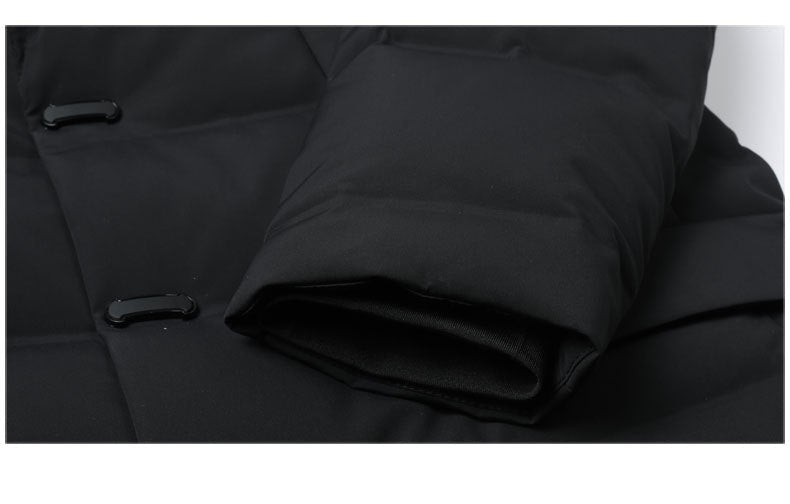 Close-up of button closure with hidden snap fastening system on black down coat