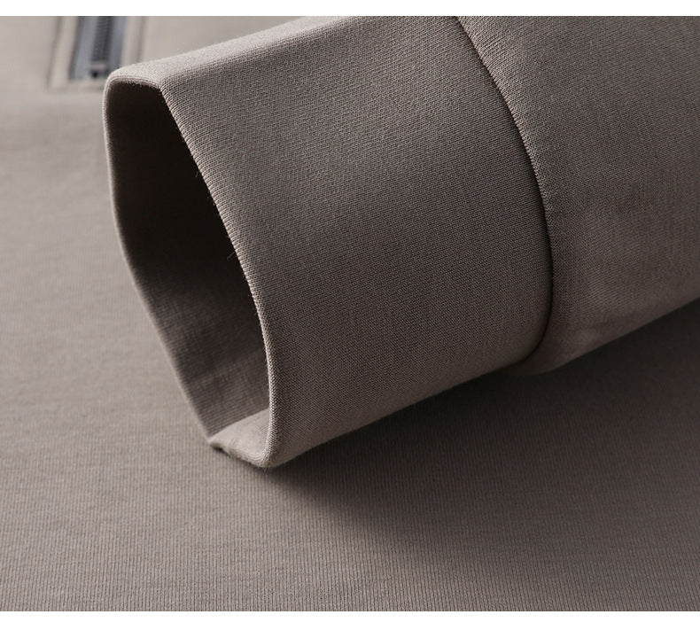 Close-up of gray cotton sleeve cuff showing ribbed texture and clean finishing